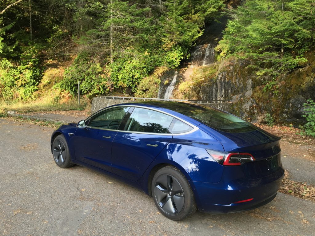 Blue Model 3 at a waterfall